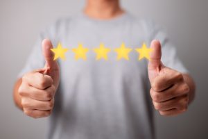 Concept of Customer Experience. With a five-star rating, a happy client gives a thumbs up for great. Excellent Services for Customer Satisfaction.